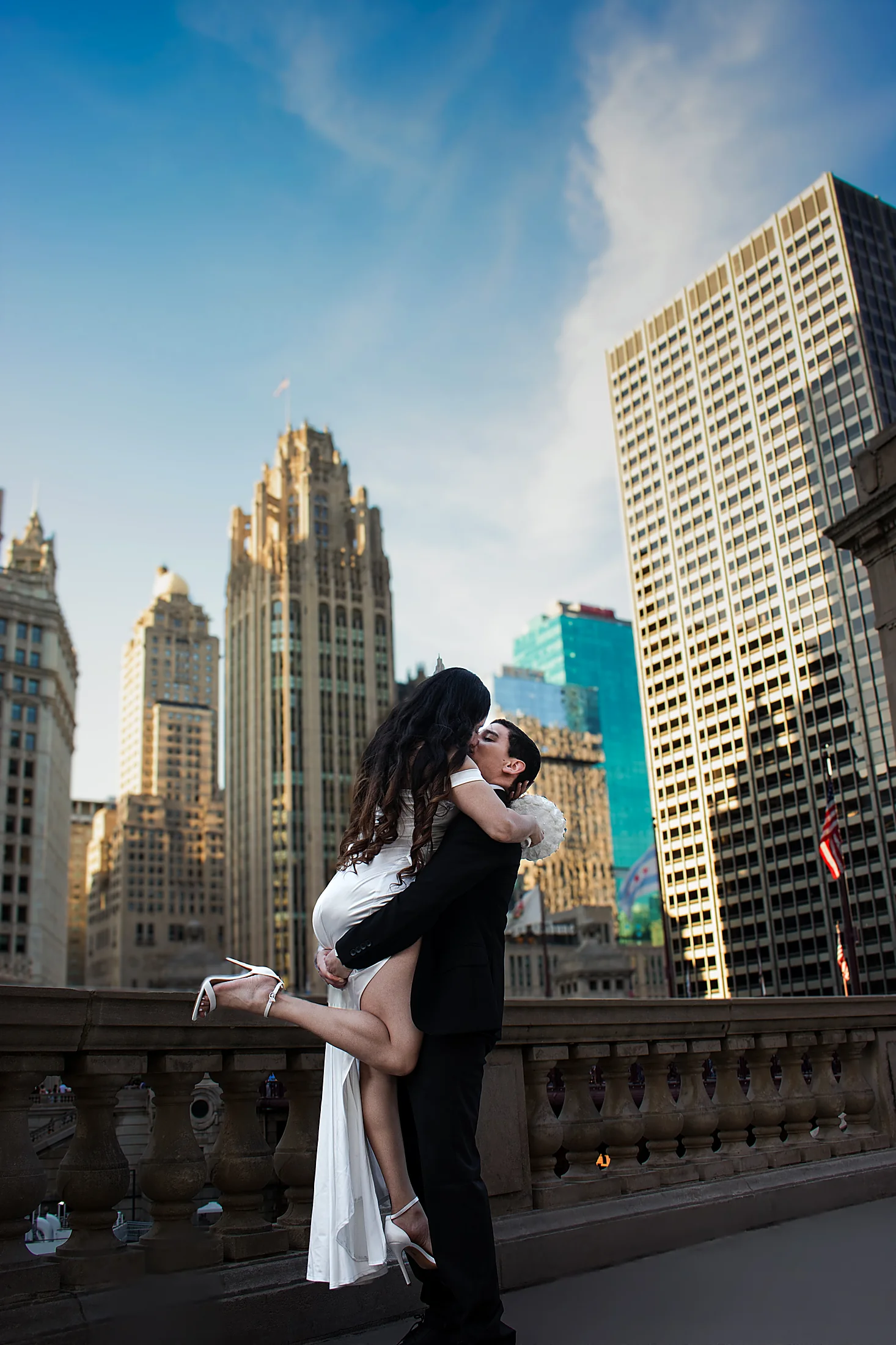 Bride and groom kissing on a Chicago rooftop balcony